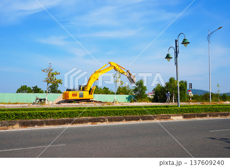 Excavator on road construction. Screeding ground for installing borders, curbs blocks at road. Excavator on road construction. Screeding ground for installing borders, curbs blocks at road. 137609240