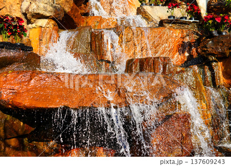 Waterfall background close-up. Drops of water flowing down rocks from waterfall. Waterfall background close-up. Drops of water flowing down rocks from waterfall. 137609243