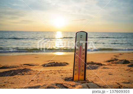 Thermometer on sunset sea beach in tropical. Extremely hot day. Thermometer measuring air  137609303