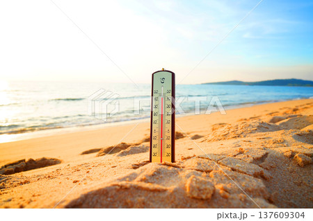 Thermometer on sunset sea beach in tropical. Extremely hot day. Thermometer measuring air  137609304