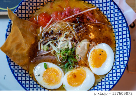 Lyon, france. December 29, 2023. Delicious ramen bowl with soft-boiled eggs, tender pork, noodles and scallions in rich, savory broth comforting japanese meal, close up Lyon, france. December 29, 2023. Delicious ramen bowl with soft-boiled eggs, tender pork, noodles and scallions in rich, savory broth comforting japanese meal, close up 137609872