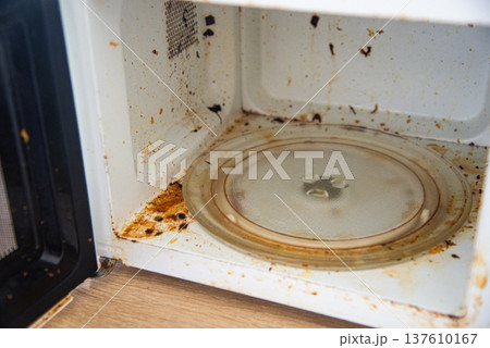 Dirty old microwave oven interior Dirty old microwave oven interior 137610167