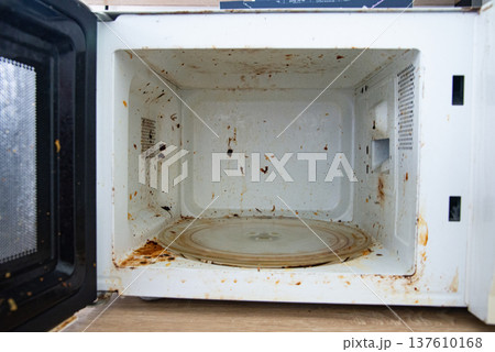Dirty old microwave oven interior Dirty old microwave oven interior 137610168