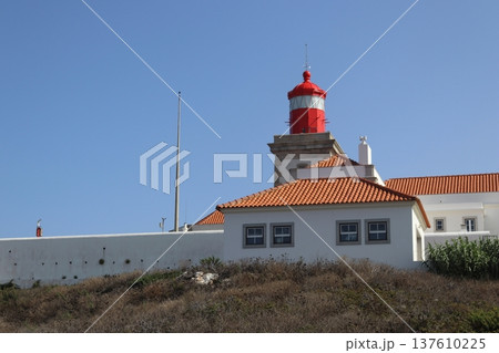 Red lighthouse tower and traditional white buildings at Cabo da Roca, Portugal. Red lighthouse tower and traditional white buildings at Cabo da Roca, Portugal. 137610225