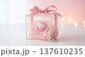 Its a Girl Baby Shower Gift in Clear Acrylic Box with Pink Pacifier on Soft Bokeh Background 137610235