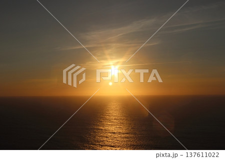 Golden Sunset Over the Atlantic Ocean with Sunstar Flare and Calm Water Golden Sunset Over the Atlantic Ocean with Sunstar Flare and Calm Water 137611022