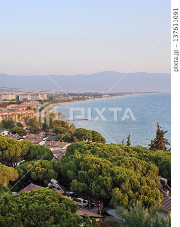 Picturesque view of turkey coast, Kusadasi, Audin, blue sea and mountain on horizon in mist. Calm water surface, background for traveling and vacation, Beautiful sea view, sea in sunny day. Picturesque view of turkey coast, Kusadasi, Audin, blue sea and mountain on horizon in mist. Calm water surface, background for traveling and vacation, Beautiful sea view, sea in sunny day. 137611091