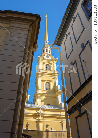 Saint Petersburg, Russia - June 20 2024, View of the bell tower of Peter and Paul Cathedral through buildings in narrow street, at daytime, no people, St Petersburg, Russia  137612333