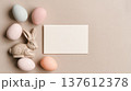 Minimal Easter mockup with ceramic bunny figurine, speckled eggs and blank greeting card, soft neutral background ideal for invitation, branding or holiday message 137612378