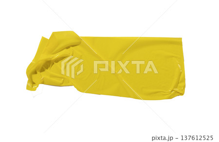 Asymmetric yellow adhesive tape piece isolated on white background. Glossy plastic surface with Asymmetric yellow adhesive tape piece isolated on white background. Glossy plastic surface with 137612525