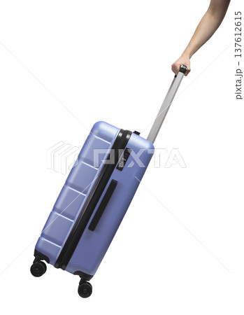 Hand pulling suitcase. Side view of large hardshell luggage with lock, zipper, and telescopic handle 137612615