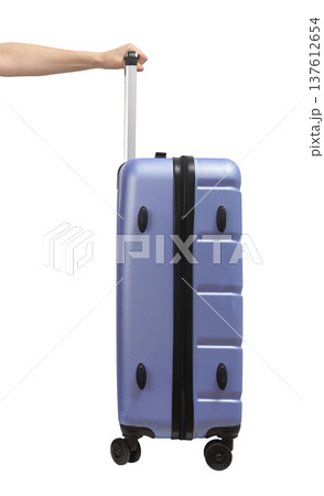 Woman pulling suitcase. Blue and purple wheeled hardcase luggage with telescopic handle and secure 137612654