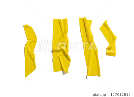 yellow adhesive tape strips isolated on white background. Narrow glossy pieces with bends, folds, 137612655
