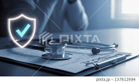 Medical stethoscope lying on patient document clipboard near glowing digital safety shield holographic icon representing healthcare insurance guarantee and secure clinic protection service 137612694