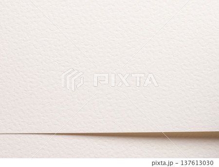 Beige textured paper with lower horizontal fold edge. Fine grain surface forms neutral composition. Minimal background. Beige textured paper with lower horizontal fold edge. Fine grain surface forms neutral composition. Minimal background. 137613030