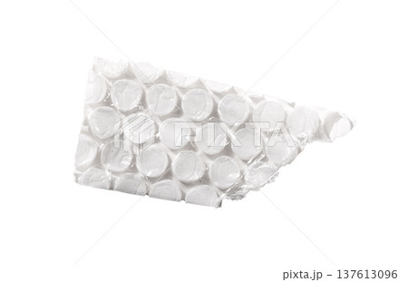 torn piece of transparent bubble wrap with pressed air cells and glossy plastic surface. Abstract torn piece of transparent bubble wrap with pressed air cells and glossy plastic surface. Abstract 137613096