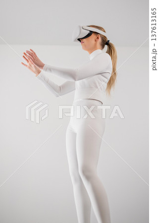 Woman Using Virtual Reality Headset 137613165