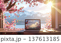 Remote working, spring. laptop on wooden desk with cherry blossoms and mountain view creates serene atmosphere 137613185