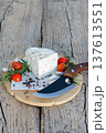 Fresh cheese with herbs served on wooden board with rosemary, tomatoes, garlic and pepper 137613551