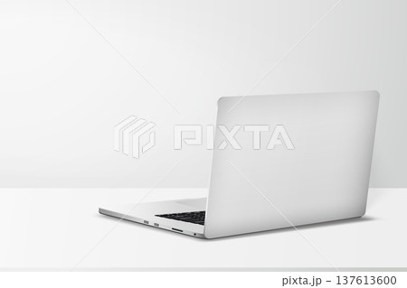 Minimal workspace with laptop back side view on table with gray wall background. Minimal workspace with laptop back side view on table with gray wall background. 137613600