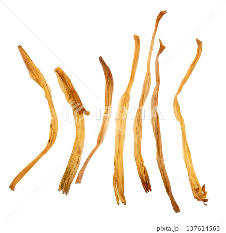 Top view of dried lily buds isolated. Common ingredient in Asian cuisine like hot and sour soup. Elongated golden yellow dried flower petals for cooking and herbal medicine. 137614563
