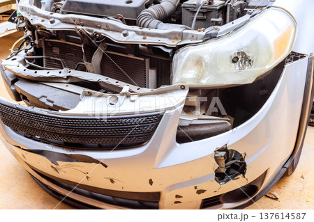 Car with damaged front showing signs of an accident in garage 137614587