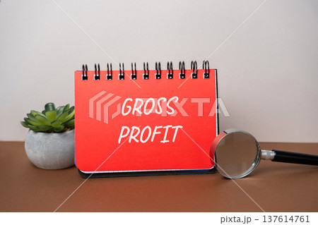 Concept of gross profit. Revenue minus cost of goods sold, business finance, accounting. Business and finance. Notepad and magnifying glass Concept of gross profit. Revenue minus cost of goods sold, business finance, accounting. Business and finance. Notepad and magnifying glass 137614761