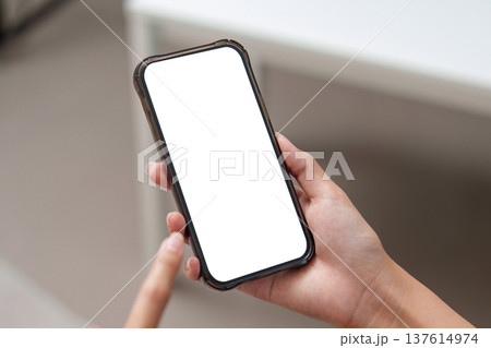 Screen Display. Close-up of hand holding smartphone with empty screen for digital marketing. Screen Display. Close-up of hand holding smartphone with empty screen for digital marketing. 137614974