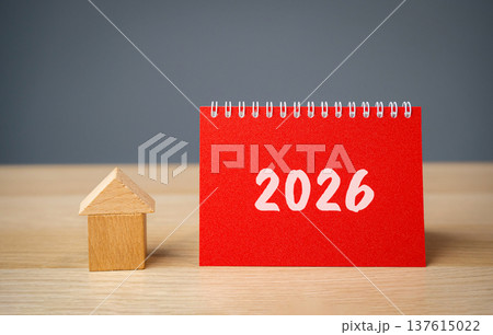 Inscription 2026 and miniature house. Family budget planning for next year. Investments, plans, savings. Mortgage rates. Real estate concept. Refinance home. 137615022