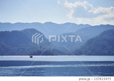 Scenic panoramic view of Lake Bled with the island church and mountains in the background Scenic panoramic view of Lake Bled with the island church and mountains in the background 137615475