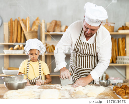 Dad and daughter cook croissants together, cut dough and have nice time 137615678