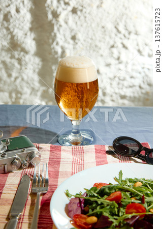 Craft beer glass with fresh salad lunch outdoor table Craft beer glass with fresh salad lunch outdoor table 137615723