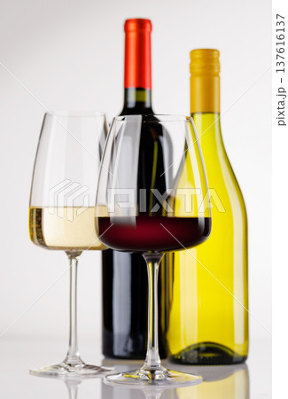 Different wine bottles and glasses on white background 137616137