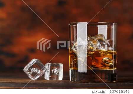 Glass of whiskey with ice 137616143