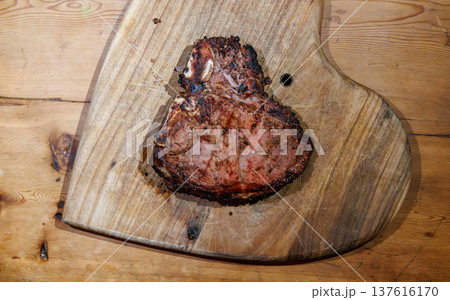 Cooked T-bone steak on wooden board Cooked T-bone steak on wooden board 137616170
