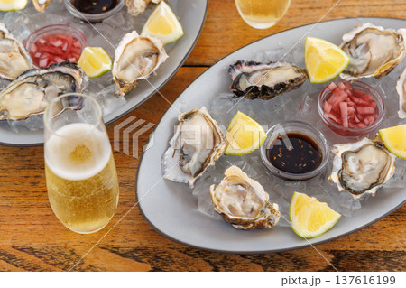 Fresh oysters on ice with champagne Fresh oysters on ice with champagne 137616199