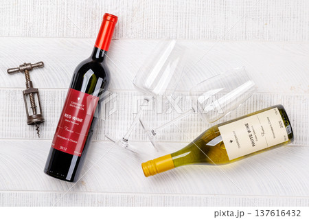 Red and white wine bottles mockup on wood 137616432