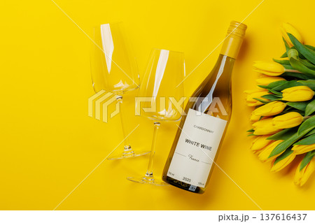 White wine bottle with yellow tulips 137616437