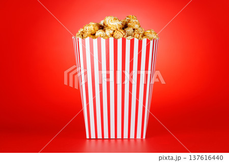 Popcorn bucket on bright red background 137616440