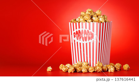 Popcorn bucket on bright red background 137616441