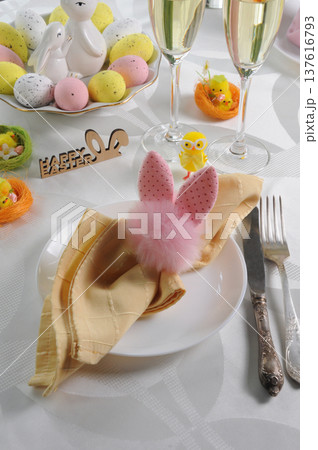 Festive Easter table setting with a decoratively folded napkin Festive Easter table setting with a decoratively folded napkin 137616793