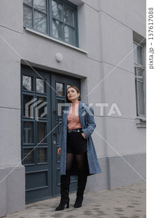 Beautiful young girl standing near wooden door on 137617088