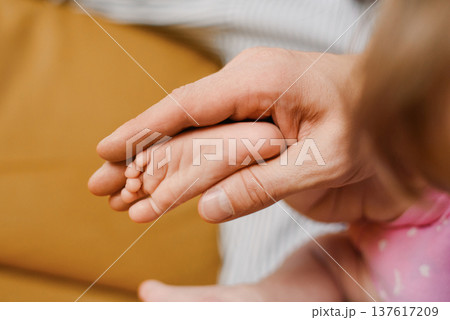 Gentle Touch Of Parent Holding Baby Foot 137617209