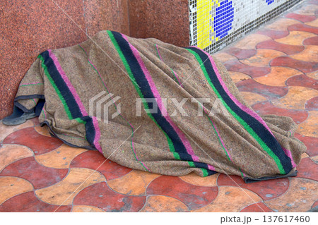 resident sleeps on the floor waiting for the train 137617460