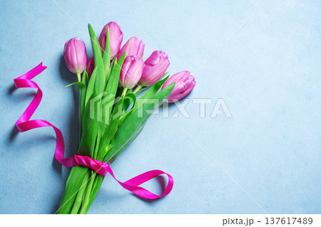 Pink tulips bouquet on blue pastel background. Spring Floral Mother's Day Mockup. 137617489