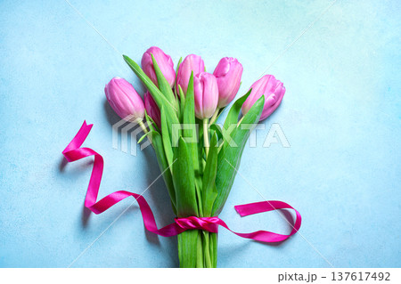 Pink tulips bouquet on blue pastel background. Spring Floral Mockup. 137617492