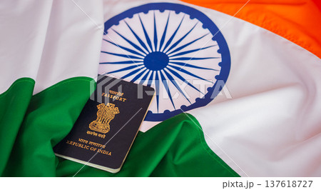 Blue Indian passport on national flag background close up. Tourism and citizenship concept 137618727