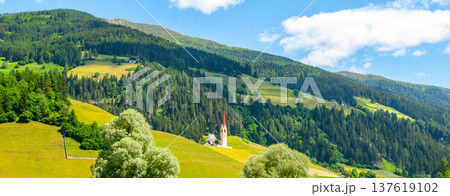 Rural church in green hilly landscape of Dolomites, Winnebach village, Italy. 137619102