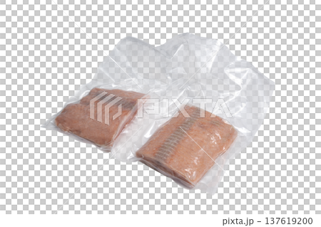 two slices of frozen salmon, closed in a plastic bag two slices of frozen salmon, closed in a plastic bag 137619200