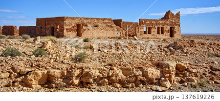 Abandoned mud building ruins in arid desert landscape Abandoned mud building ruins in arid desert landscape 137619226